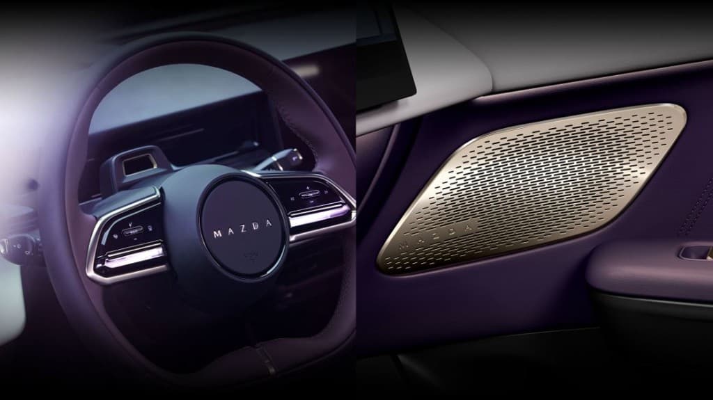 Mazda EZ-60 — detalle de volante y acabados de puerta con altavoz premium